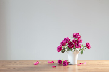 purple roses in vase on white background - 794949468