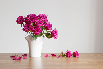 purple roses in vase on white background - 794952285