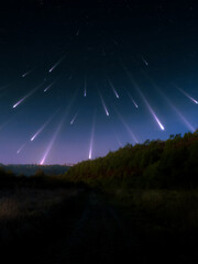 Spectacular star rain in the sky. A landscape with a stream of meteors. Fireballs over the hills.