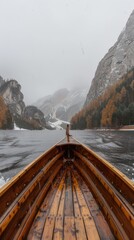 wooden boat on the lake in mountains, foggy weather, beautiful scener