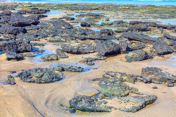 Rocky beach at low tide on the coast of Atlantic ocean in Portugal