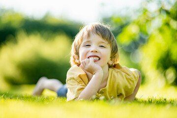 Adorable little boy having fun outdoors on sunny summer day. Kid running outdoors. Child exploring nature. Summer activities for small kids. - 794961817