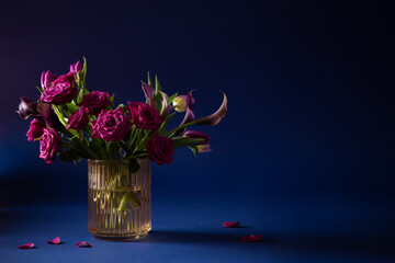 beautiful flowers in glass vase on blue background - 794962880