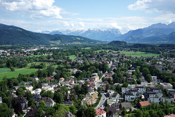 View of Salzburg with snow-capped mountains in the background.