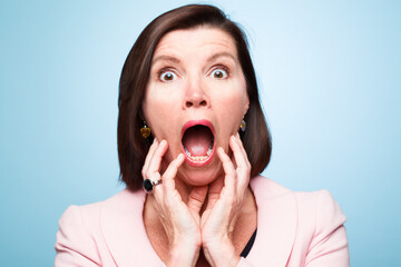 Portrait, wow and surprise of shocked woman with horror, fear or scared in studio isolated on blue background. Face, omg and wtf announcement of model with secret, news or emoji expression for gossip - obrazy, fototapety, plakaty