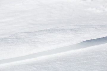 Close up of thin ledge of windswept sparkling snow abstract background