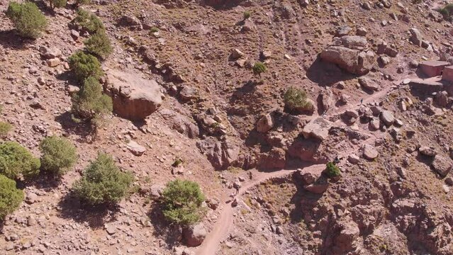 Toubkal, Morocco - A group of young travlers in a mountain going on a trip in Toubkal in the Atlas Mountains - CIRCA 2021