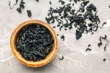 Dried wakame seaweed in bowl on kitchen table. Top view. - 794991000