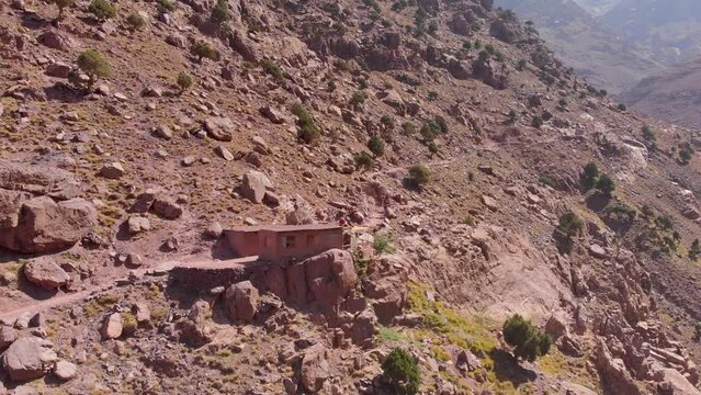 Toubkal, Morocco - A group of young travlers in a mountain going on a trip in Toubkal in the Atlas Mountains - CIRCA 2021