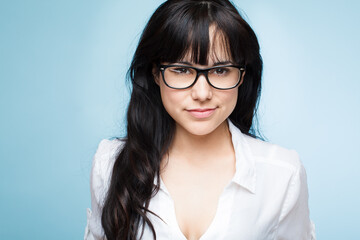 Studio, smile and portrait of woman with glasses for eye care, clear vision and wellness on blue...