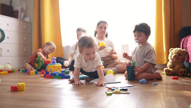 children play at home. happy and full of joy childhood, children's dream concept. a group of children of different ages spend time playing together, various colorful lifestyle toys lie nearby