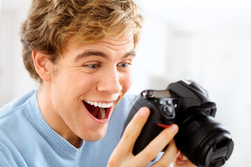 Man, camera and happy to check picture, home and photography for media or photo art. Male person,...