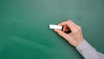 Hand writing on a clean green chalkboard, perfect for educational content and tutorials.