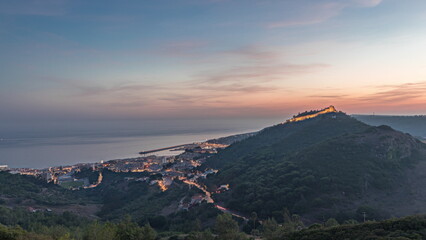 Panorama showing aerial view of Sesimbra Town and Port day to night timelapse, Portugal.