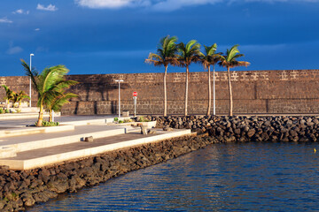 Embankment of Arrecife city of Lanzarote. Palm trees on the waterfront of the port of Canary Islands