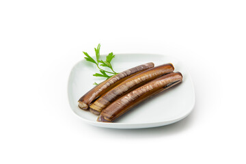 Fresh razor clams neatly arranged on a white square plate, garnished with a sprig of green parsley, isolated on a white background