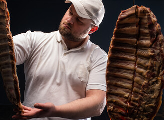  butcher looks at the dried ribs