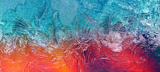 Photo of a frozen window with a colorful background outside the window. Natural texture of ice on...