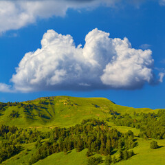 green mountain chain under blue cloudy sky