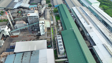 An aerial drone captures the bustling activity outside a paper and packaging factory. Numerous...