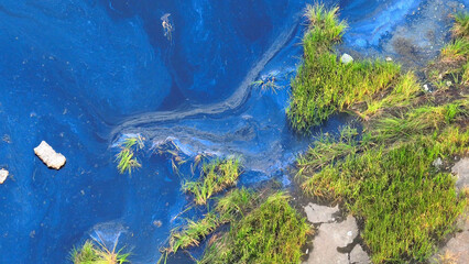 Industrial wastewater flows into surface water, causing pollution, harming aquatic life, and posing risks to ecosystems. Point Source Pollution and groundwater Pollution concept. Aerial view drone.
