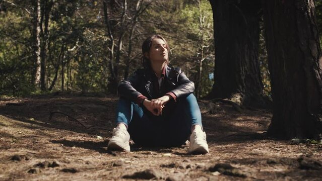 Young female in the forest alone. Sunny day. cinematic.