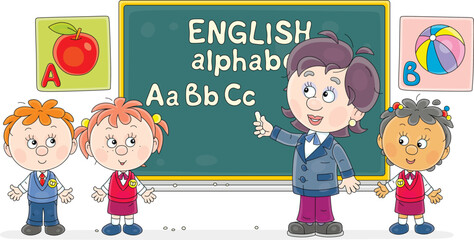 Teacher writing with chalk letters of English alphabet on a blackboard in a class and telling about them to funny little schoolchildren at a lesson in primary school, vector cartoon illustration