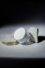 cosmetic cream container with shades on marble