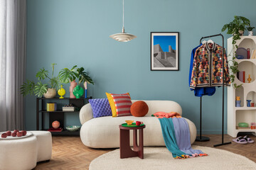 Modern and colorful interior of living room with design boucle sofa, mock up poster, shelf, plants,...