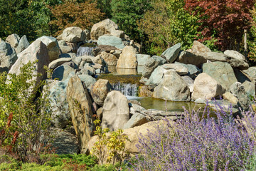 Triple waterfall splits into three streams in Japanese garden. Public landscape park of Krasnodar...