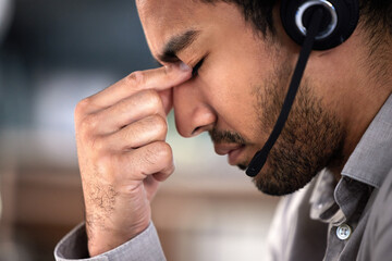 Man, stress and headset as employee at call center with customer or client support and service. Office, crm and advisor or consultant with fatigue, burnout and tired with headache and overtime