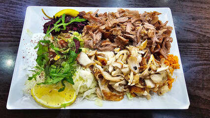 A dish of Doner Kebab meat and leafy vegetables, a staple food on the table Hanover Germany