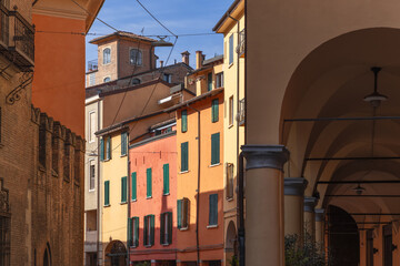 The warm hues of Bologna architecture are on display, with famous covered porticoes leading the eye...