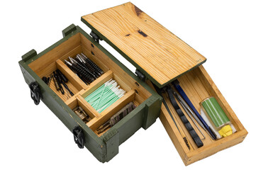 Interior of a military style wooden box with a firearm cleaning and maintenance kit on a white...