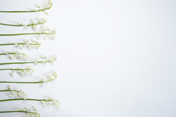 Composition of flowers flat lay from lilies of the valley on a white background. Top view and copy...