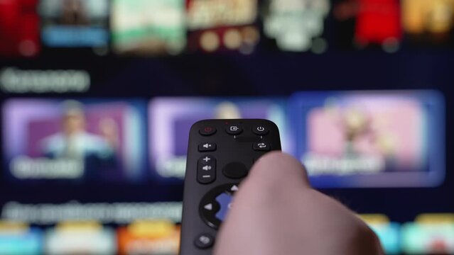 Streaming service Internet Online Cinema Smart TV Channel Surfing. Hand Holding the TV Remote Control Smart Television and then Turn it off . TV Stick