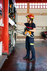 A woman in her 40s and 50s works as a firefighter dressed in her work uniform.The adult woman takes...