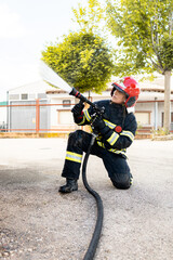 A woman in her 40s and 50s works as a firefighter dressed in her work uniform.The adult woman gets...