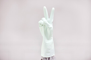 Person, cleaner or hands for peace sign in gloves for good job with mockup space on grey...