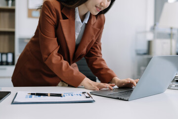Business women hand working with tablet and laptop computer with documents on office desk