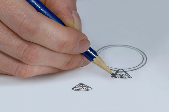 The work of a jeweler-designer. A jewelry designer develops sketches of jewelry. Design studio. Creative ideas.