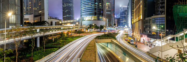 Traffic with streets and skyscrapers at night panorama in city of Hong Kong, China