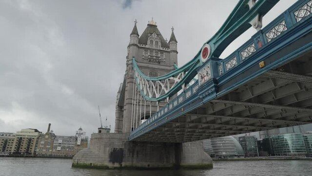 London, United Kingdom - People crossing the Tower Bridge bascule and suspension bridge over River Thames