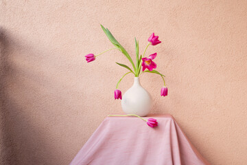 tulips in vase on table on background wall - 795090617