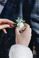 white boutonniere on a blue jacket