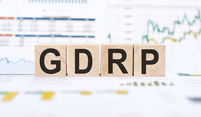 Wooden blocks are arranged on a desk to spell out the acronym GDPR, representing the General Data...