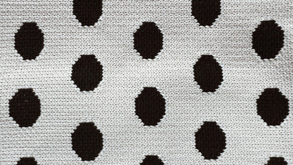 Polka dot fabric close-up. Macro view of textured black polka on white cloth. Backdrop for vintage style design. Film grain texture. Soft focus. Blur