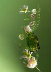 flying flowers in green glass  vase on green background - 795105062