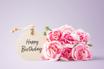 Happy birthday card with pink flowers on purple background