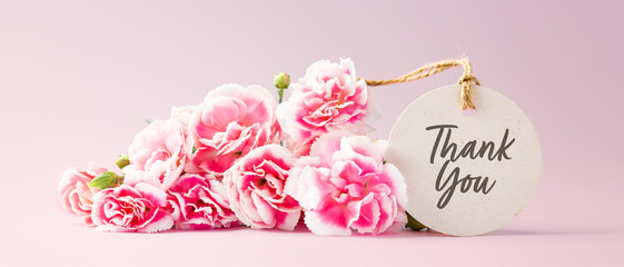 Thank you tag with pink carnation flower bouquet on pastel pink background